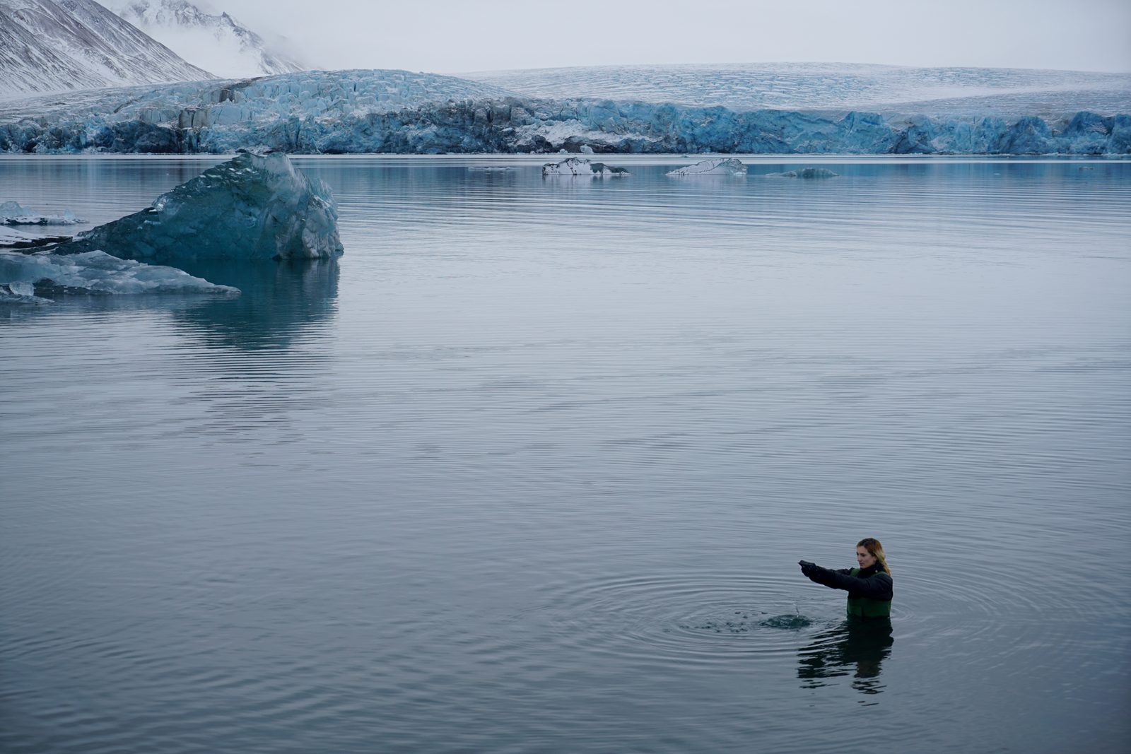 The Reluctant Good Bye: the artist waist-deep in Arctic water before a glacier